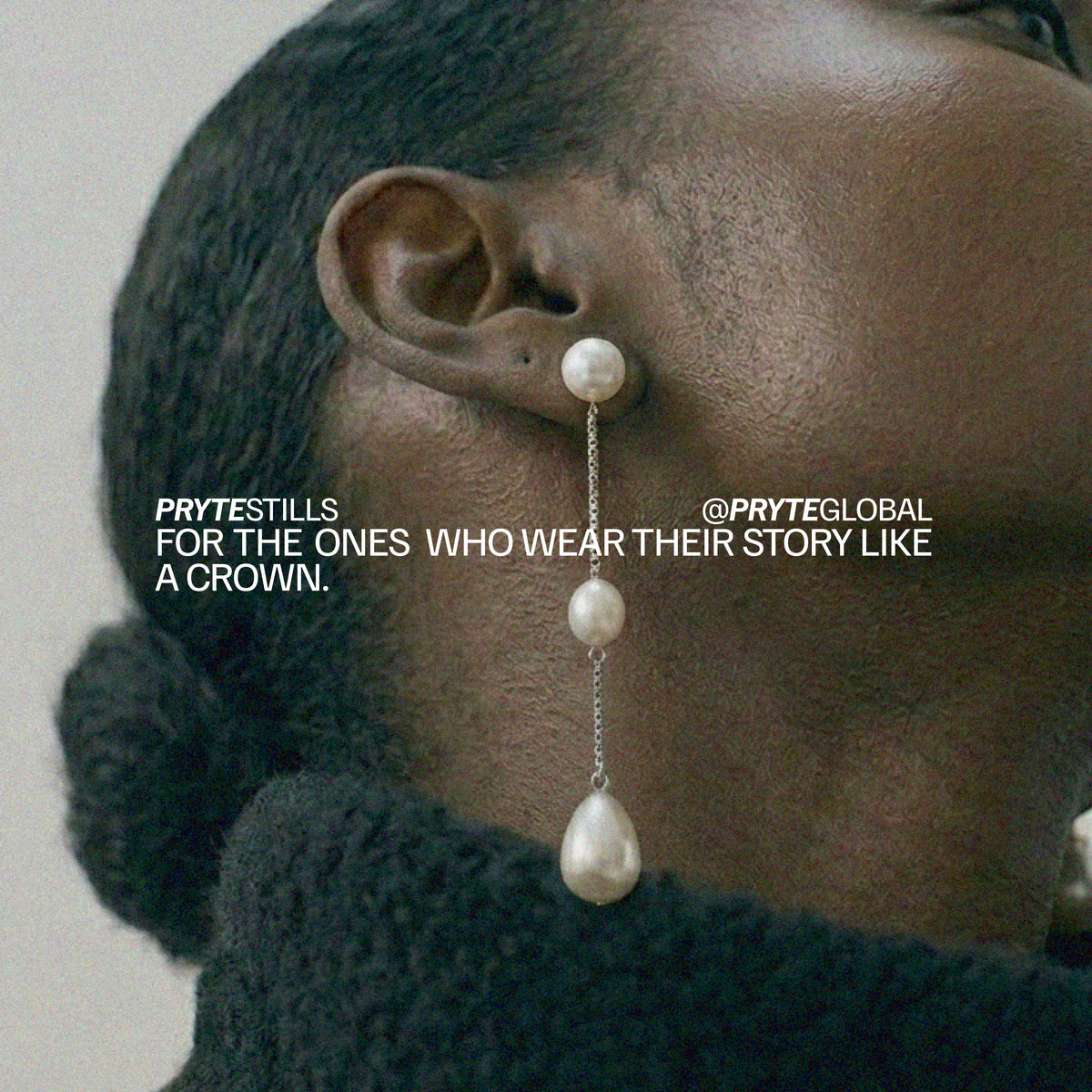 Pryte long anchor pearl earrings worn by a person with text overlay on a neutral background